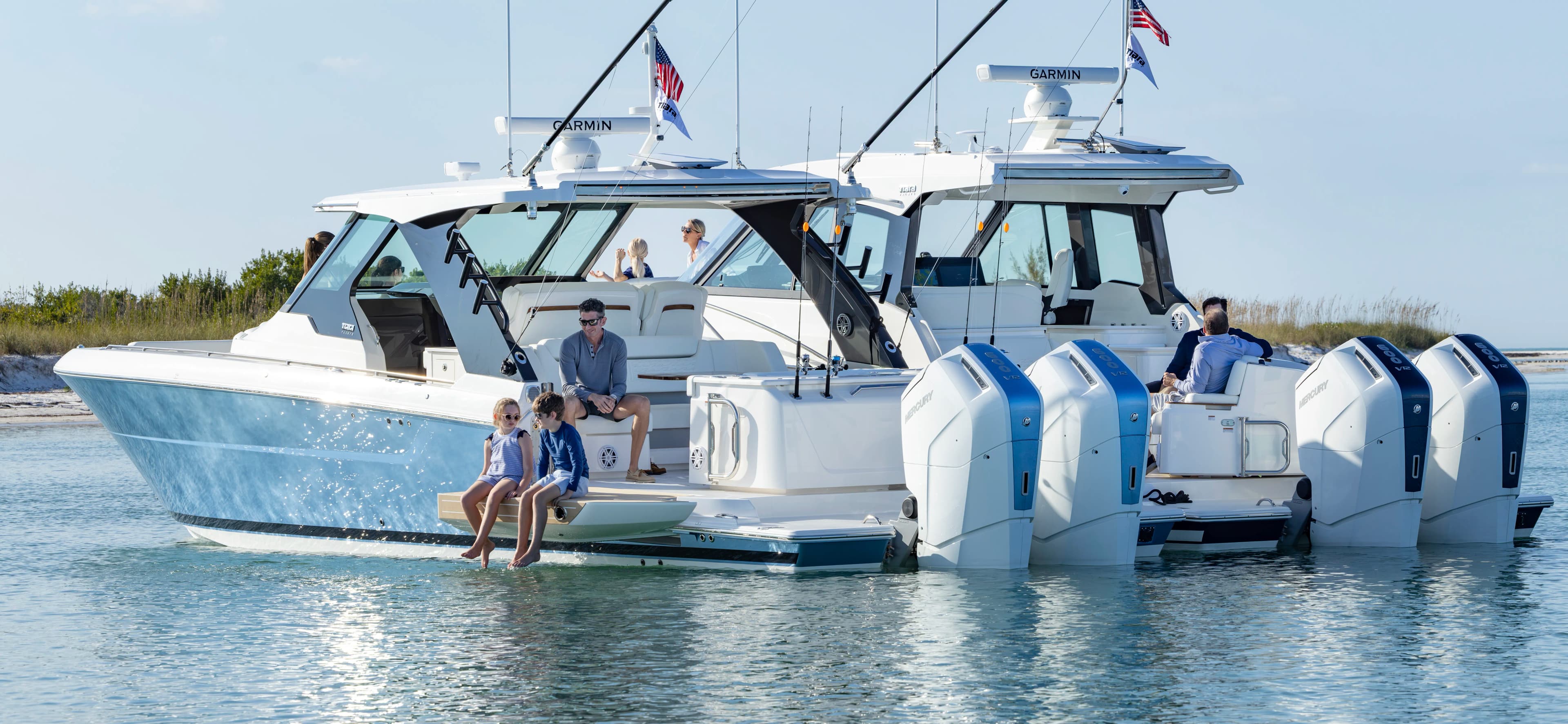 Family fishing off the terrace of the 39 LS, buoyed up the 39 LE with guests in aft lounge. 