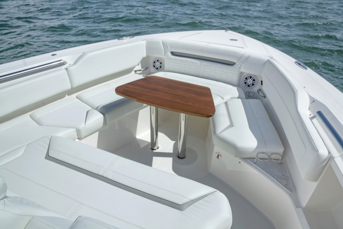 Bow seating with high-gloss teak table with dedicated storage