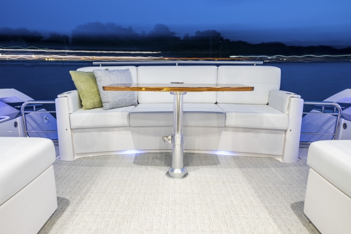 Tiara Yachts 44 Coupe | Aft Cockpit lounge with high-gloss teak table