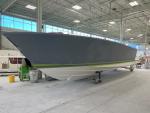 Hull is fresh out of the paint booth with primer and will now move to the assembly line