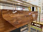 Solid teak table surfaces are installed