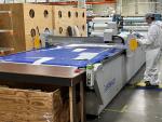 Eastman machine cutting fiberglass cloth pieces for smaller fiberglass parts