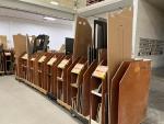 Cabin, seating and cabinet parts are organized onto carts before going to assembly