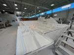 Hull is being prepared for assembly; All accessible bilge and machinery spaces receive a white gel coat finish
